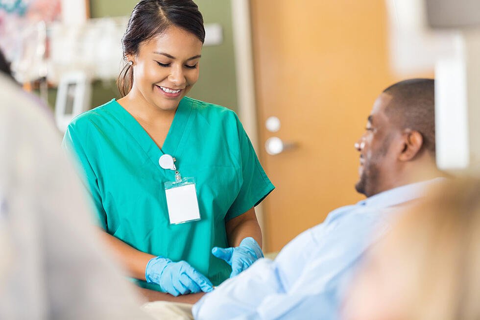 Healthcare provider preparing to draw blood from a patient's arm
