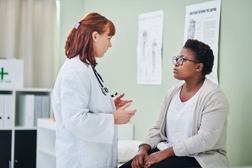 Female doctor speaking to a patient